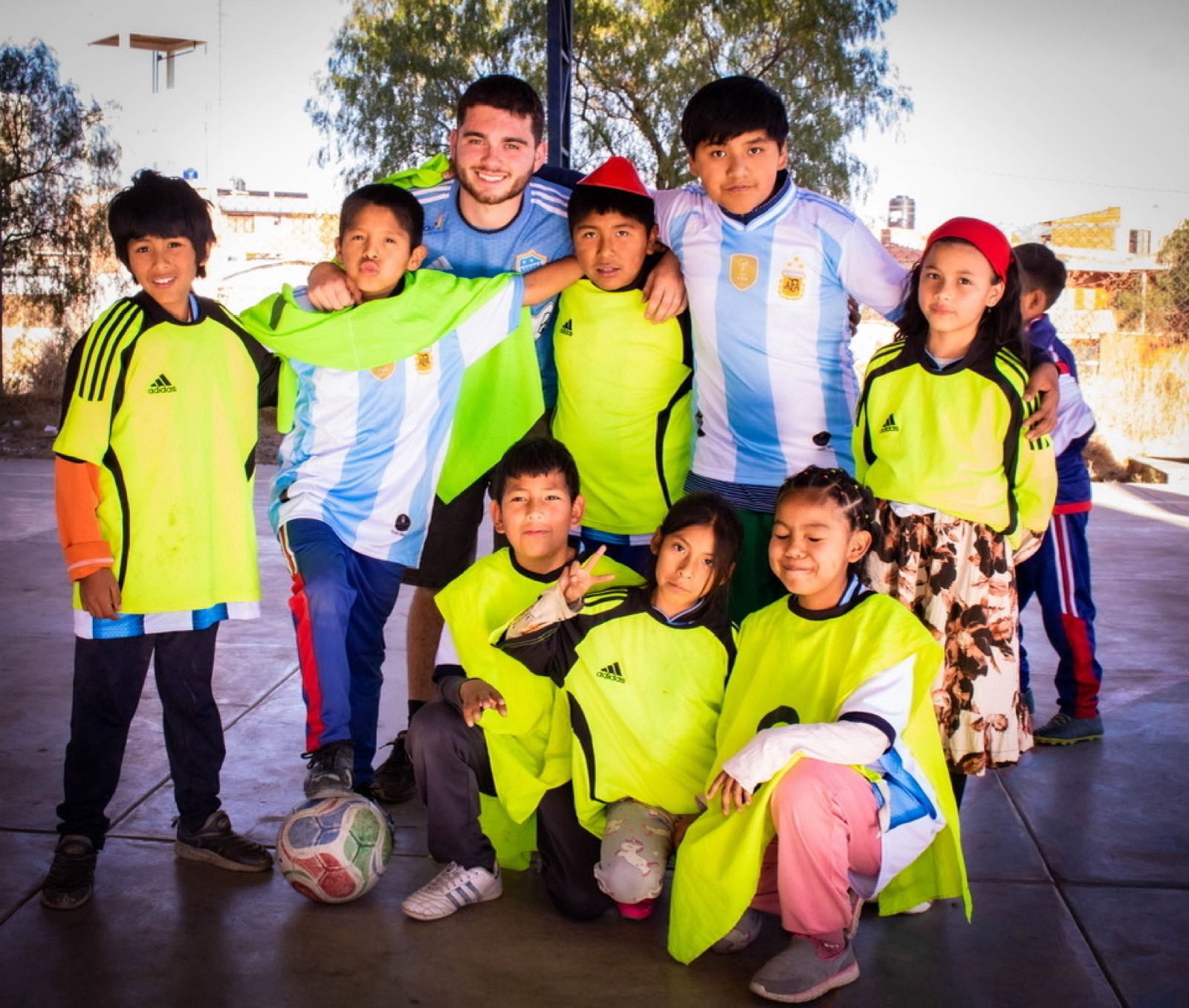 Football at the centre with a volunteer and the children