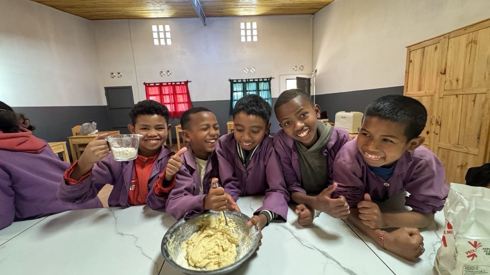 Cooking class: five boys mixing dough and laughing