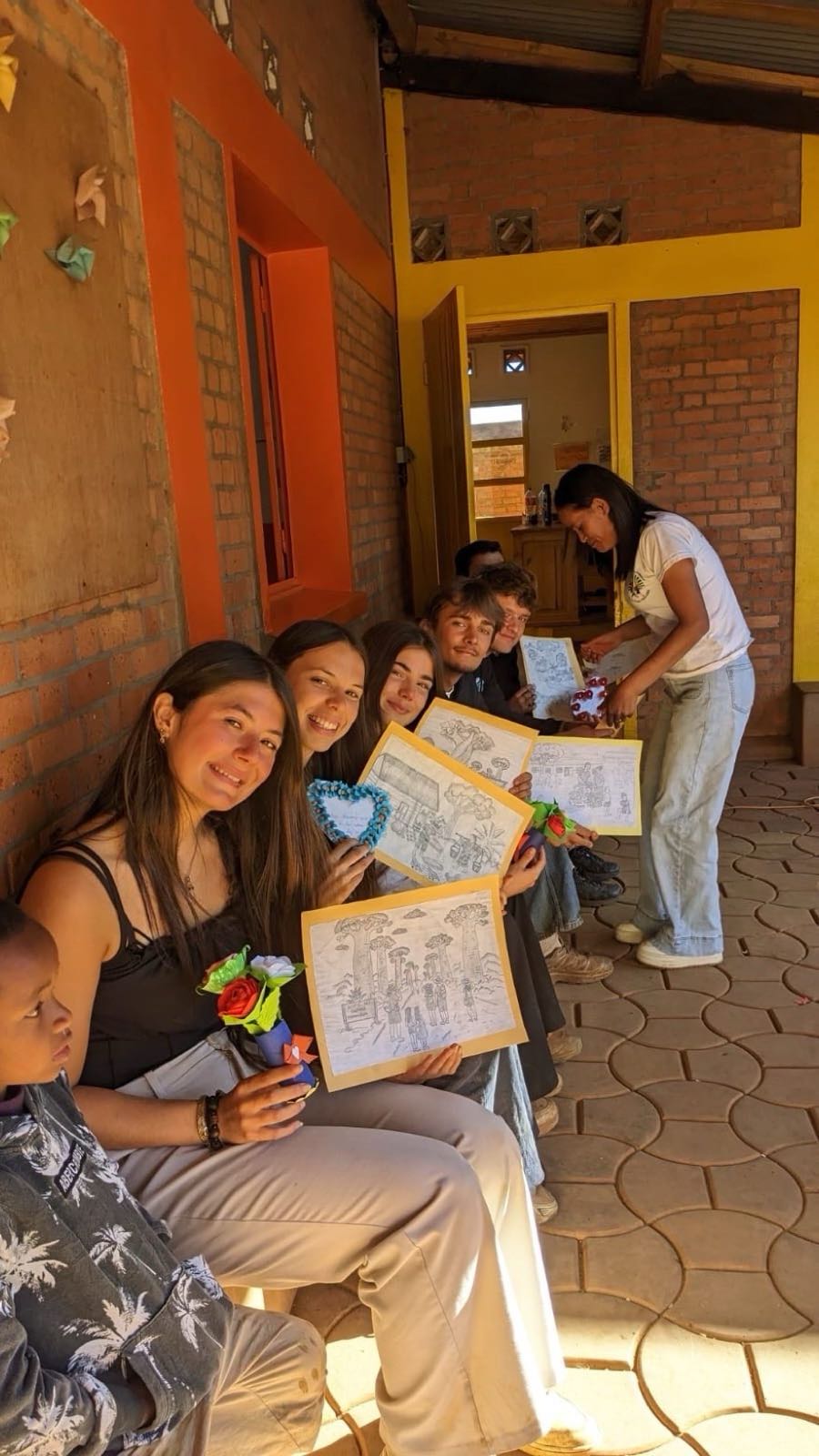Volunteers showing the drawings the children gave them