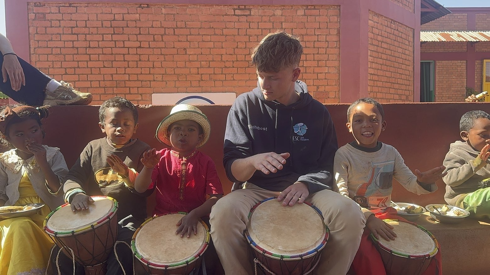 A volunteer playing djembe with the children from the centre, in Madagascar
