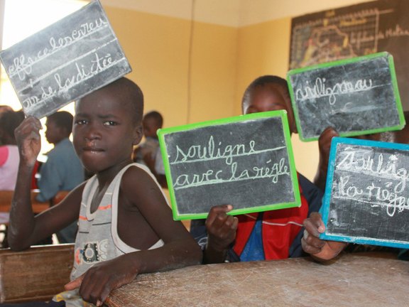 Pupils showing their slates at a school in Senegal