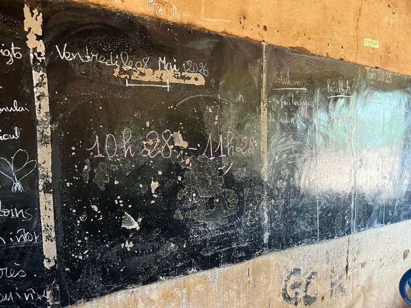 A worn blackboard in a partner school, May 2026
