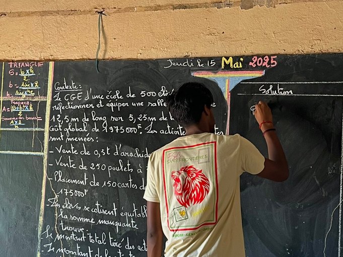 A pupil at the blackboard during a maths lesson